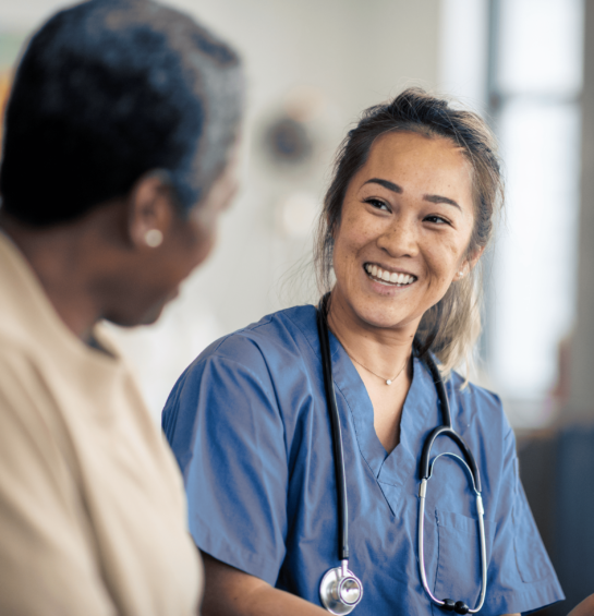 A nurse smiling at an older woman