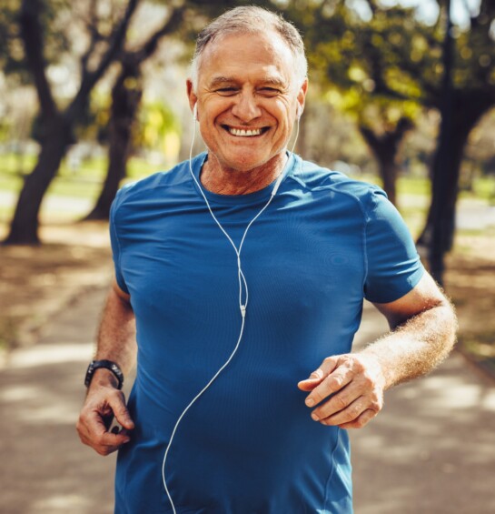 Man in blue shirt jogging outside.